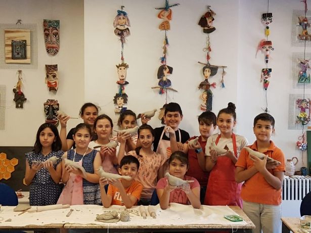Children who are attending the pottery classes of the art centre are visible in the picture